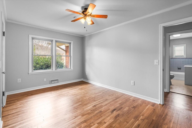 spare room with ornamental molding, ceiling fan, and hardwood / wood-style flooring