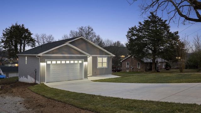 view of front of house with a garage and a yard