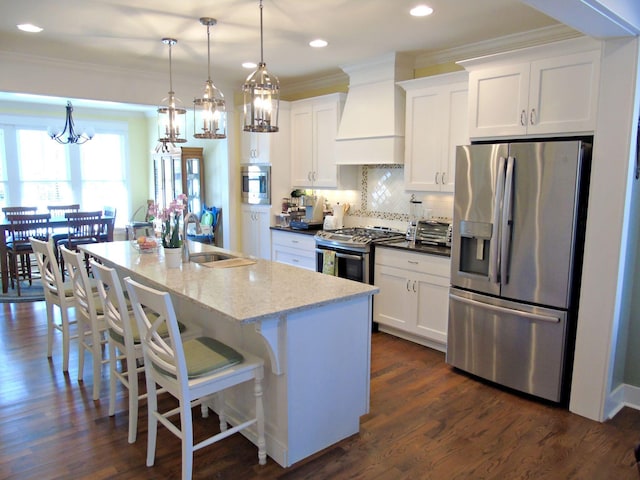 kitchen with light stone countertops, appliances with stainless steel finishes, sink, and white cabinets