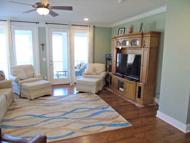 living room with crown molding, dark hardwood / wood-style floors, and ceiling fan