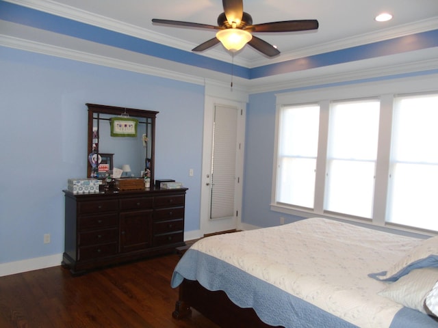 bedroom featuring ceiling fan, ornamental molding, and dark hardwood / wood-style floors