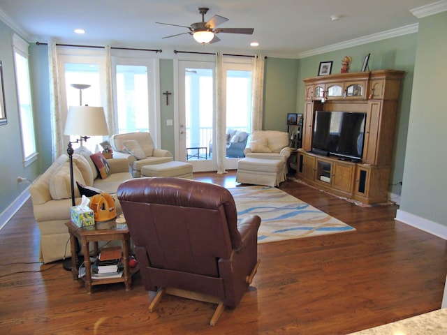 living room with crown molding, ceiling fan, and dark wood-type flooring