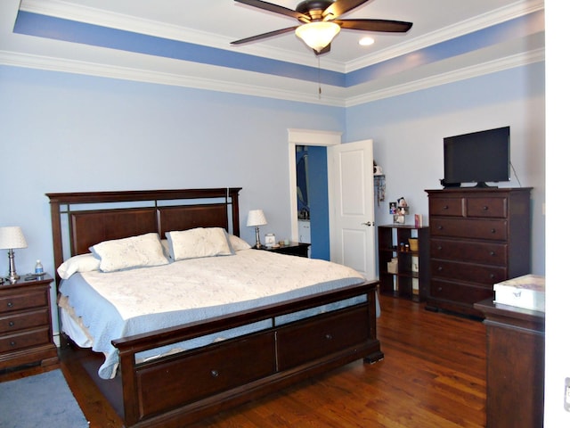 bedroom featuring crown molding, ceiling fan, a tray ceiling, and dark hardwood / wood-style floors