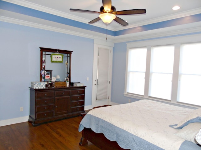 bedroom with dark wood-type flooring, ornamental molding, and ceiling fan