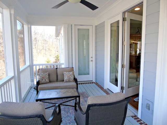 sunroom / solarium featuring ceiling fan