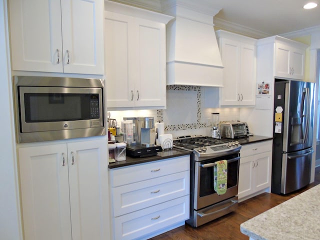 kitchen featuring custom exhaust hood, ornamental molding, dark hardwood / wood-style floors, stainless steel appliances, and white cabinets