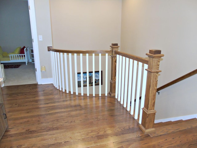 staircase with wood-type flooring