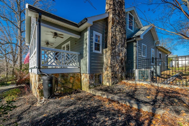 view of home's exterior with ceiling fan and a balcony