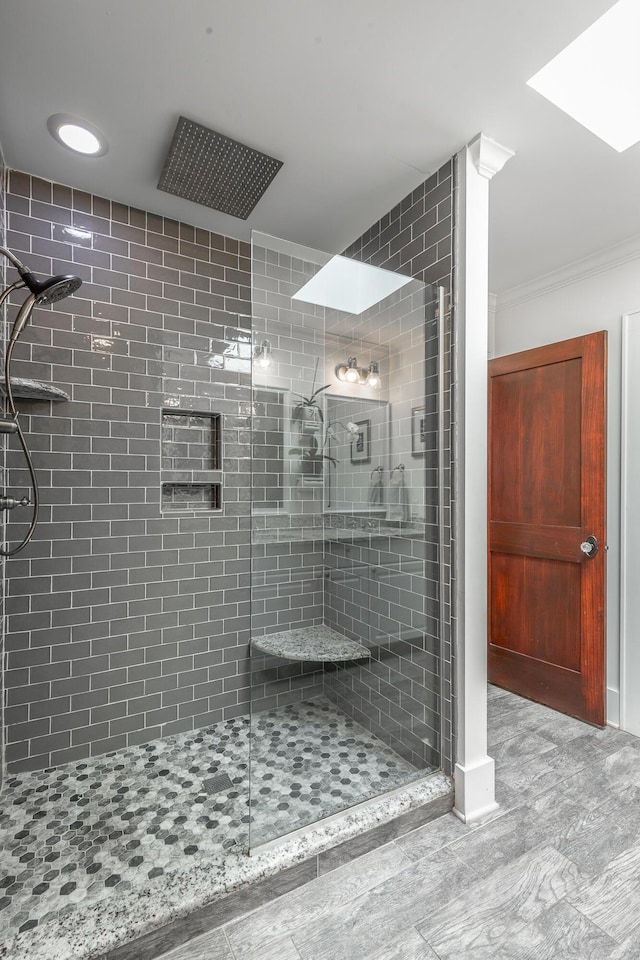 bathroom featuring walk in shower and ornamental molding