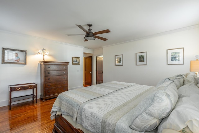 bedroom with ceiling fan, ornamental molding, and hardwood / wood-style floors