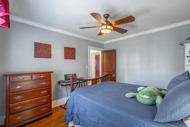 bedroom with ceiling fan, ornamental molding, and hardwood / wood-style flooring