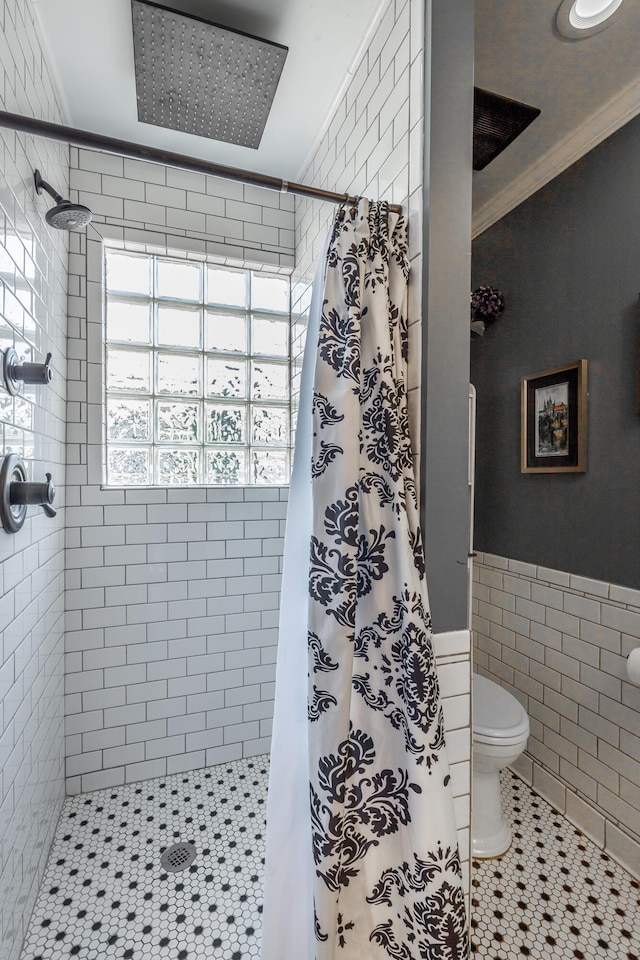 bathroom featuring walk in shower, toilet, tile walls, tile patterned floors, and crown molding