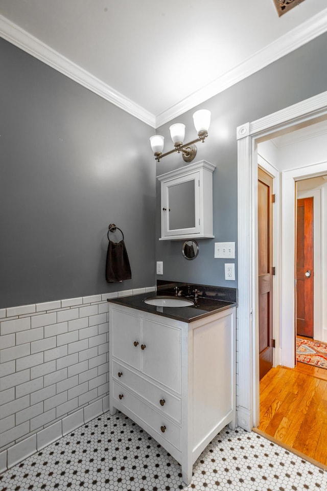 bathroom with crown molding, tile patterned floors, and vanity