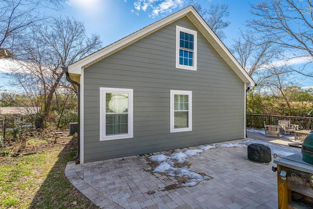 rear view of house featuring cooling unit and a patio area