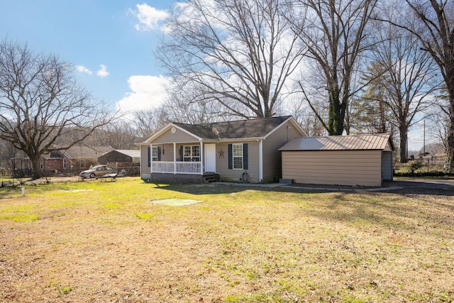 view of front of property with a front yard, a porch, and a storage shed