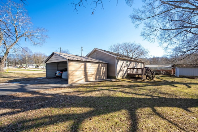 view of outbuilding featuring a yard and a carport