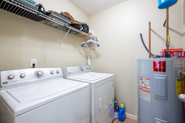 clothes washing area featuring washer and clothes dryer and electric water heater