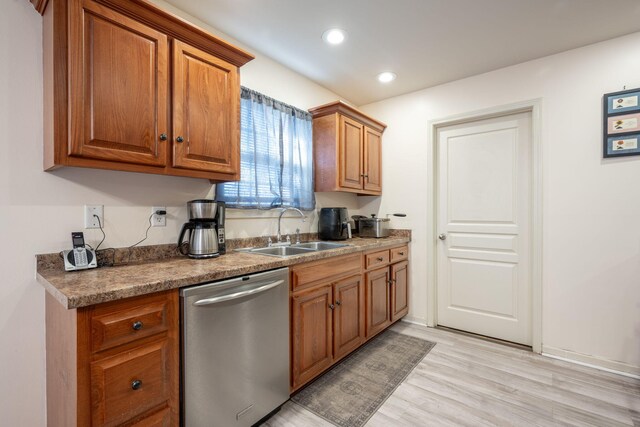 kitchen with dishwasher, light hardwood / wood-style flooring, and sink