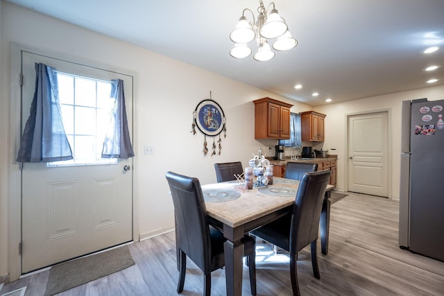 dining room with a notable chandelier and light hardwood / wood-style flooring