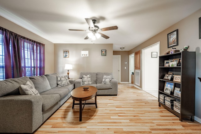 living room with ceiling fan and light hardwood / wood-style flooring