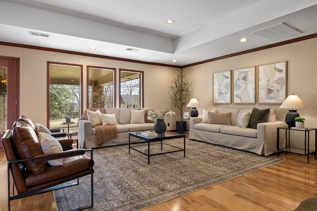 living room featuring crown molding and hardwood / wood-style flooring