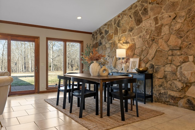 tiled dining area featuring ornamental molding