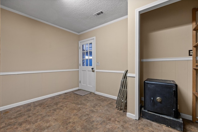 entryway featuring crown molding and a textured ceiling