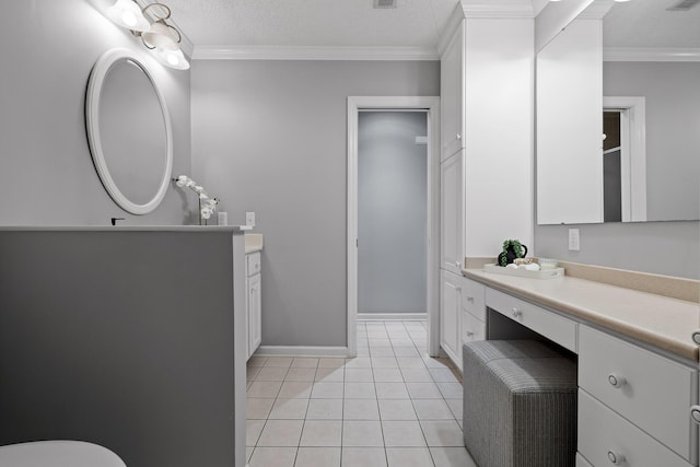 bathroom with vanity, ornamental molding, tile patterned floors, and a textured ceiling