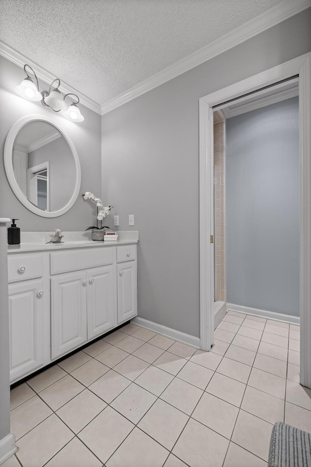 bathroom with crown molding, vanity, tile patterned flooring, and a textured ceiling