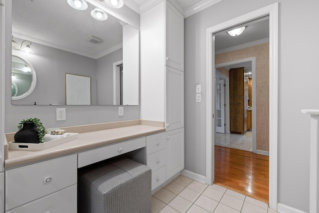 bathroom with tile patterned flooring, vanity, and ornamental molding