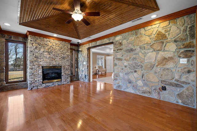 unfurnished living room with hardwood / wood-style floors, a fireplace, ornamental molding, vaulted ceiling, and wooden ceiling