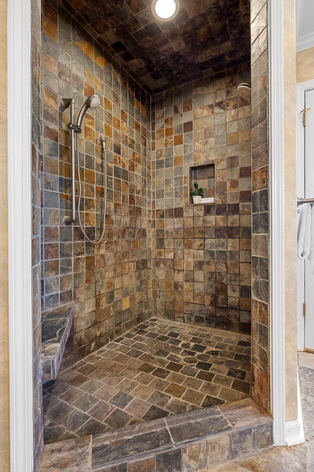 bathroom with tiled shower