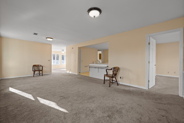 unfurnished living room with light colored carpet