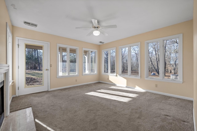 unfurnished sunroom featuring ceiling fan