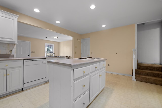 kitchen with sink, white appliances, white cabinets, and a kitchen island