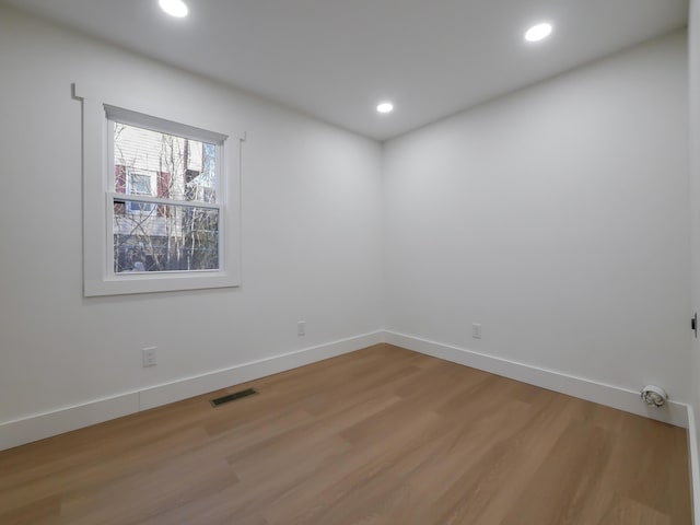 spare room featuring wood-type flooring