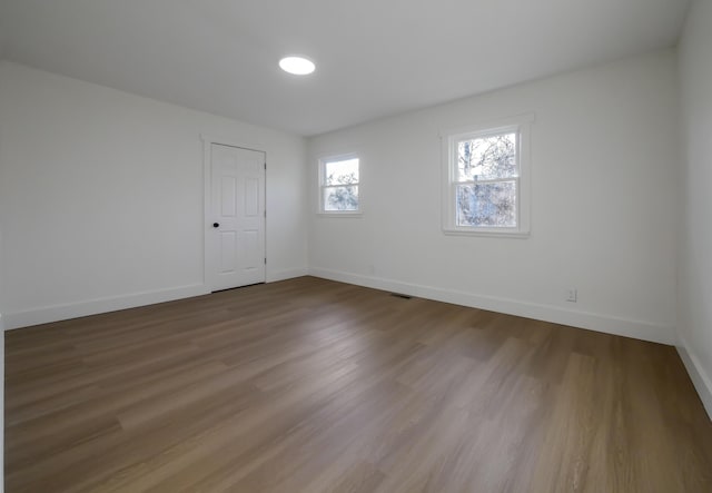 empty room with hardwood / wood-style flooring