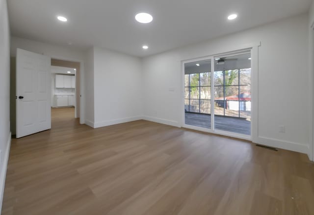 spare room featuring ceiling fan and light hardwood / wood-style flooring