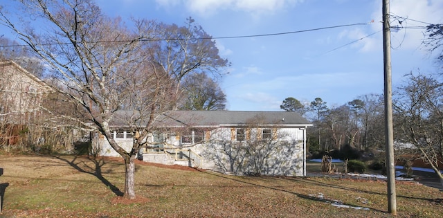 view of side of home featuring a lawn