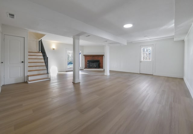 unfurnished living room with light hardwood / wood-style floors and a fireplace