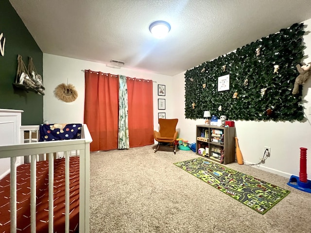 bedroom featuring carpet floors and a textured ceiling