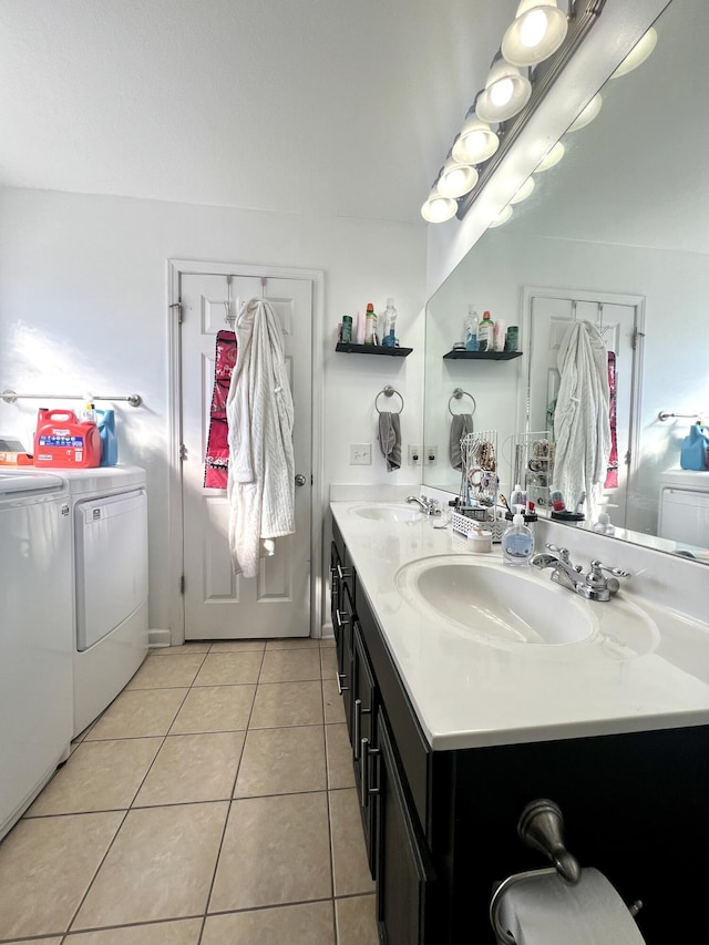 bathroom featuring vanity, tile patterned floors, and washing machine and clothes dryer