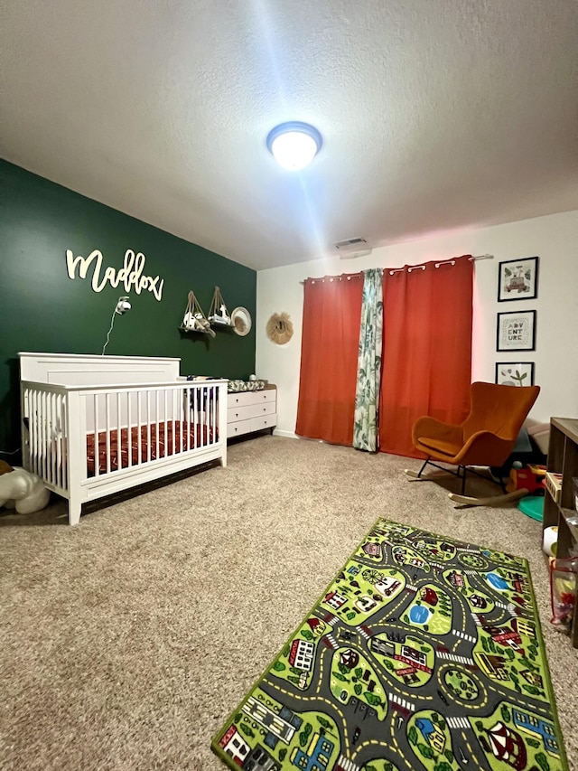 carpeted bedroom featuring a textured ceiling