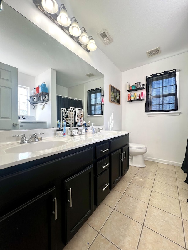 bathroom with tile patterned flooring, vanity, and toilet