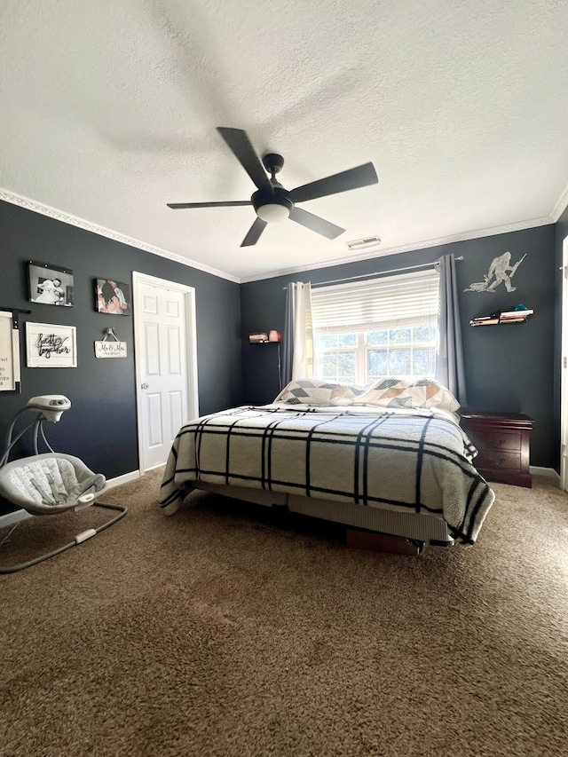 carpeted bedroom featuring ceiling fan, ornamental molding, and a textured ceiling