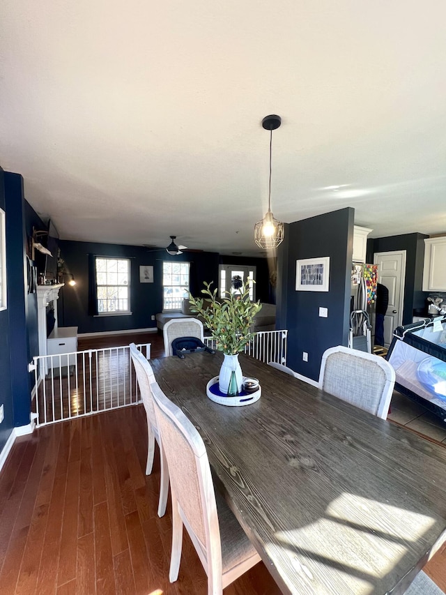 dining area with dark hardwood / wood-style flooring and ceiling fan