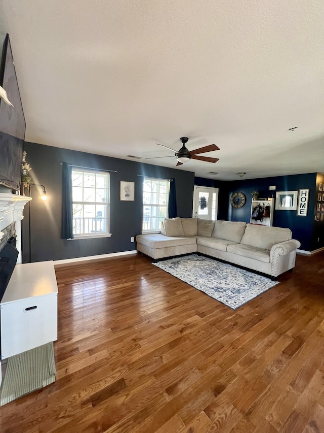 living room with wood-type flooring and ceiling fan