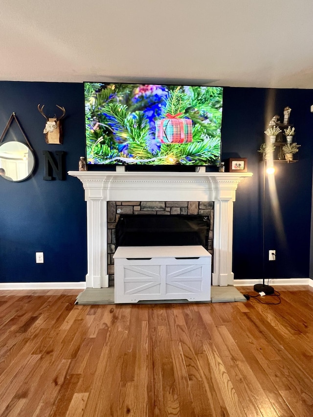 unfurnished living room with a fireplace and hardwood / wood-style floors