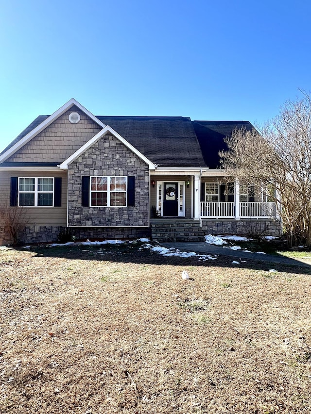 single story home with a front lawn and a porch