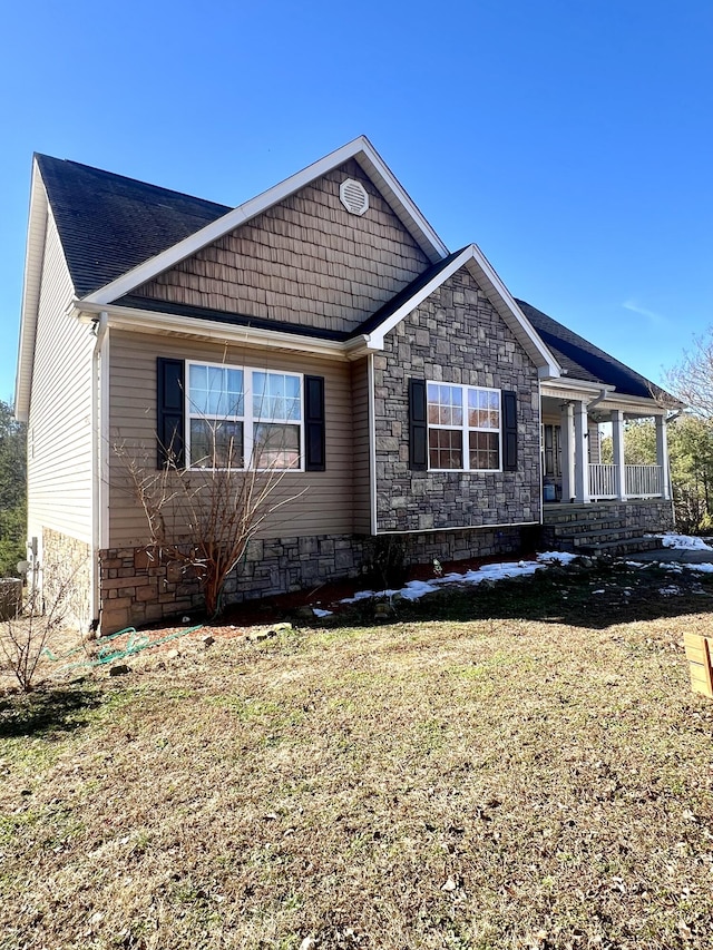 view of front facade with a front yard and covered porch